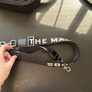 The Marc Jacob’s printed black purse strap silver hardware